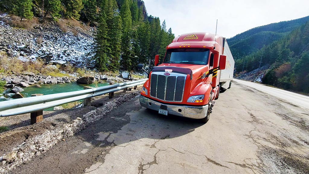 18-wheeler next to forest